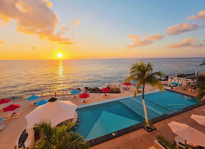 Coral Princess Hotel & Dive Resort in Cozumel with oceanfront pool and sunset beach view