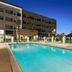 Element Ontario Rancho Cucamonga poolside at night with illuminated outdoor pool and lounge chairs