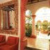Plaza Magnolias in San Cristóbal de las Casas, colonial lobby with red chairs and arched courtyard view