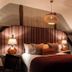 Bel and The Dragon-Cookham in Maidenhead bedroom with king bed, striped accent wall, and bedside lamps