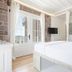 Cunda Piano Otel in Ayvalik room with bed, French doors, and glass wall overlooking the sea