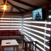 The Sarigerme Inn in Sarigerme lounge with sofas, TV, and striped window blinds