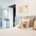 Auberge La Fontaine Aux Bretons in Pornic, bright bedroom with floral pillows and framed wall art