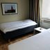 Hotel Göingehof, Hässleholm: simple twin room with two single beds, framed wall art, and window light