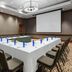 The Westin Washington National Harbor meeting room with U-shaped conference table and projector screen