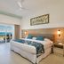 Hotel Riu Latino, Cancún guest room with king bed and balcony ocean view