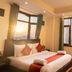 Hotel Woodrina in Shimla guest room with double bed and large windows overlooking mountain views