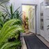 Villa Maki, Ohrid: plant-lined hotel entrance with open door and carpeted walkway