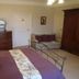 Manor Farm B&B in Marlborough bedroom with iron bed, dresser, wardrobe and floor lamp