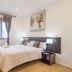 AYZ Javier Cabrini in Madrid guest room with double bed, window curtains, lamps and minimalist decor