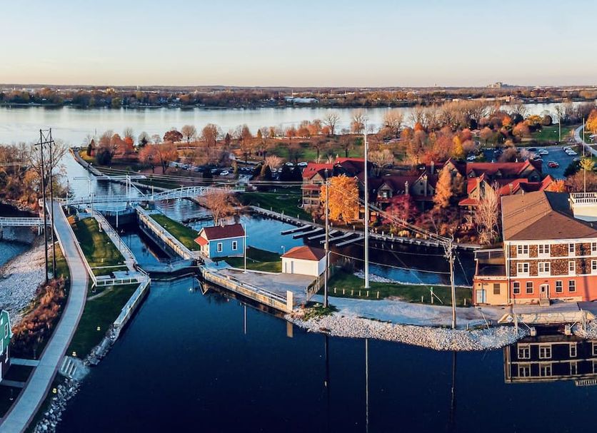 Nuk's Executive Suites in De Pere with riverfront harbor, docks, and autumn trees