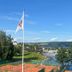 Gjøvik Hovdetun Hostel in Gjøvik with lake view, tennis courts, and a flagpole in the foreground