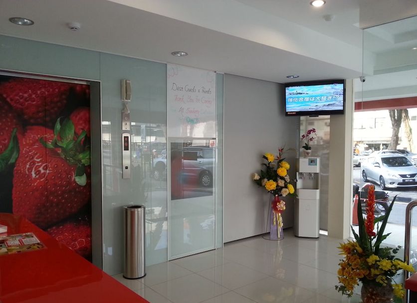 Hotel Strawberry Fields in Petaling Jaya lobby with strawberry wall art and floral arrangements