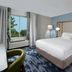 Fairfield Inn by Marriott Greensboro Airport guest room with king bed, floor lamp, and window view in Greensboro
