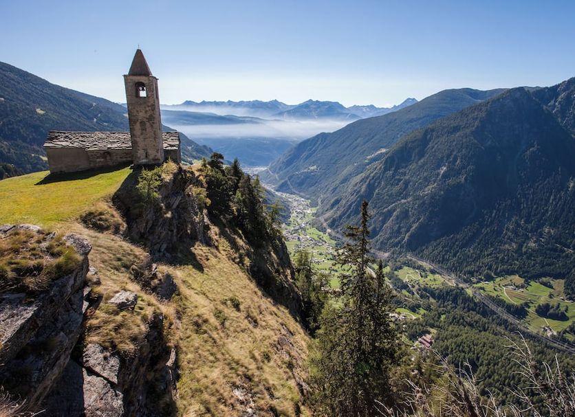 Hotel La Romantica in Poschiavo with alpine mountain and valley views from a hilltop chapel