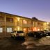 Countryman Motor Inn in Dubbo exterior at dusk with parked cars in front of two-story motel rooms