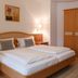 Hotel Kachelburg in Dieblich guest room with twin beds, wooden wardrobe and open closet