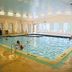 Yarmouth Resort indoor pool in West Yarmouth with large windows and lounge chairs