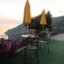 Il Borgo di Campi in Riomaggiore: seaside terrace with tables, umbrellas and ocean views at sunset