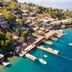 Baldan Suites Hotel & Restaurant in Bozburun overlooking a turquoise bay with docks and boats