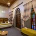 Dar Fes Tresor in Fez guest room with patterned tiles, stained-glass doors, and twin daybed