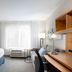 TownePlace Suites by Marriott Fort Walton Beach-Eglin AFB guest room with bed, desk, window, and seating
