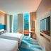 Aloft Seoul Gangnam room with two beds, colorful accents, and city view in Seoul