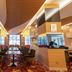 Yichang Guobin Bandao Hotel lobby lounge in Yichang with seating and wood-paneled columns