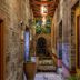 Yangshuo Secret Garden in Guilin, stone corridor with potted plants and wooden beams