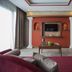 Hotel Del Sole in Pompei lounge with wall-mounted TV, columns, coffee table and colorful mural
