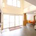 Lodge Koropokkuru lobby in Niseko with tall windows, sliding glass doors, and a seating area
