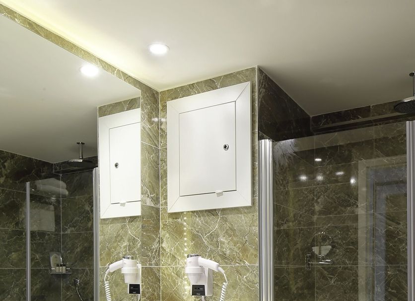 Mia Berre Hotels Istanbul bathroom with double vanity, large mirror, marble walls, and glass shower