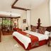 Neptune Beach Resort in Mombasa guest room with king bed, sitting area and balcony view