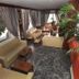Evans Hotel, Heraklion lounge with sofas, large windows, curtains and indoor plants