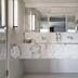 Baumanière - Les Baux de Provence bathroom with marble double sink vanity and open shelving in Les Baux-de-Provence