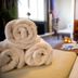Hotel Bristol Verbier spa room with rolled towels on a bed in Bagnes