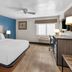 Baymont by Wyndham Arlington At Six Flags Dr room with king bed, desk and window in Arlington