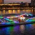 Yanjiang East Garden Inn in Guangzhou with a neon-lit river cruise boat at dusk