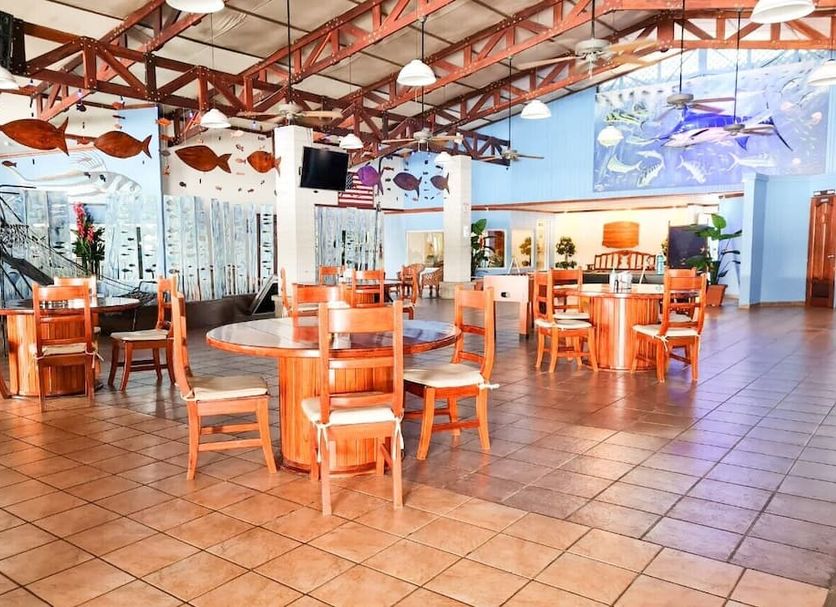Fish Hook Marina & Lodge in Golfito dining area with wooden tables, chairs, and marine-themed decor