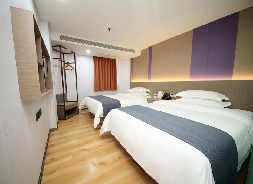 7 Days Inn Shenzhen Huaqiang Science Museum Subway Station guest room with twin beds and wood flooring