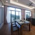 Nova Highlands Hotel Brinchang suite with dining table, sofa seating, and mountain-view windows