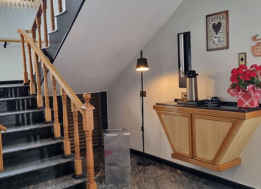 Pleasant Place Hotel in Sao Paulo staircase landing with wooden banister and wall-mounted shelf