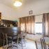 Sun City Hotel Tel Aviv lounge with bar counter, tables and chairs, window curtains, and vase of flowers