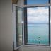 Open window in Gythion Hotel, Gytheio, framing a calm sea view with distant shoreline