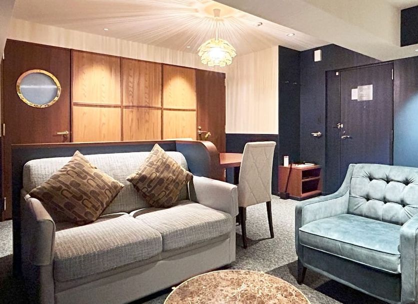 Nakajimaya Grand Hotel in Shizuoka guest room with sofa, armchair, and desk seating