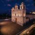 La Casa de Mamapán Hotel Colonial Ahuachapán exterior at dusk with illuminated colonial chapel-style facade