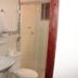 Pousada Innova in Natal bathroom with sink, toilet, and glass-enclosed shower