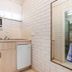 Burwood East Motel kitchenette with sink, mini fridge and wall-mounted air conditioner in Burwood East