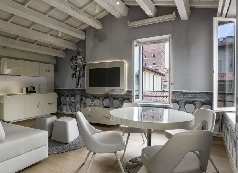 Lords of Verona Luxury Apartments in Verona living room with round table and open window city view