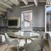 Lords of Verona Luxury Apartments in Verona living room with round table and open window city view